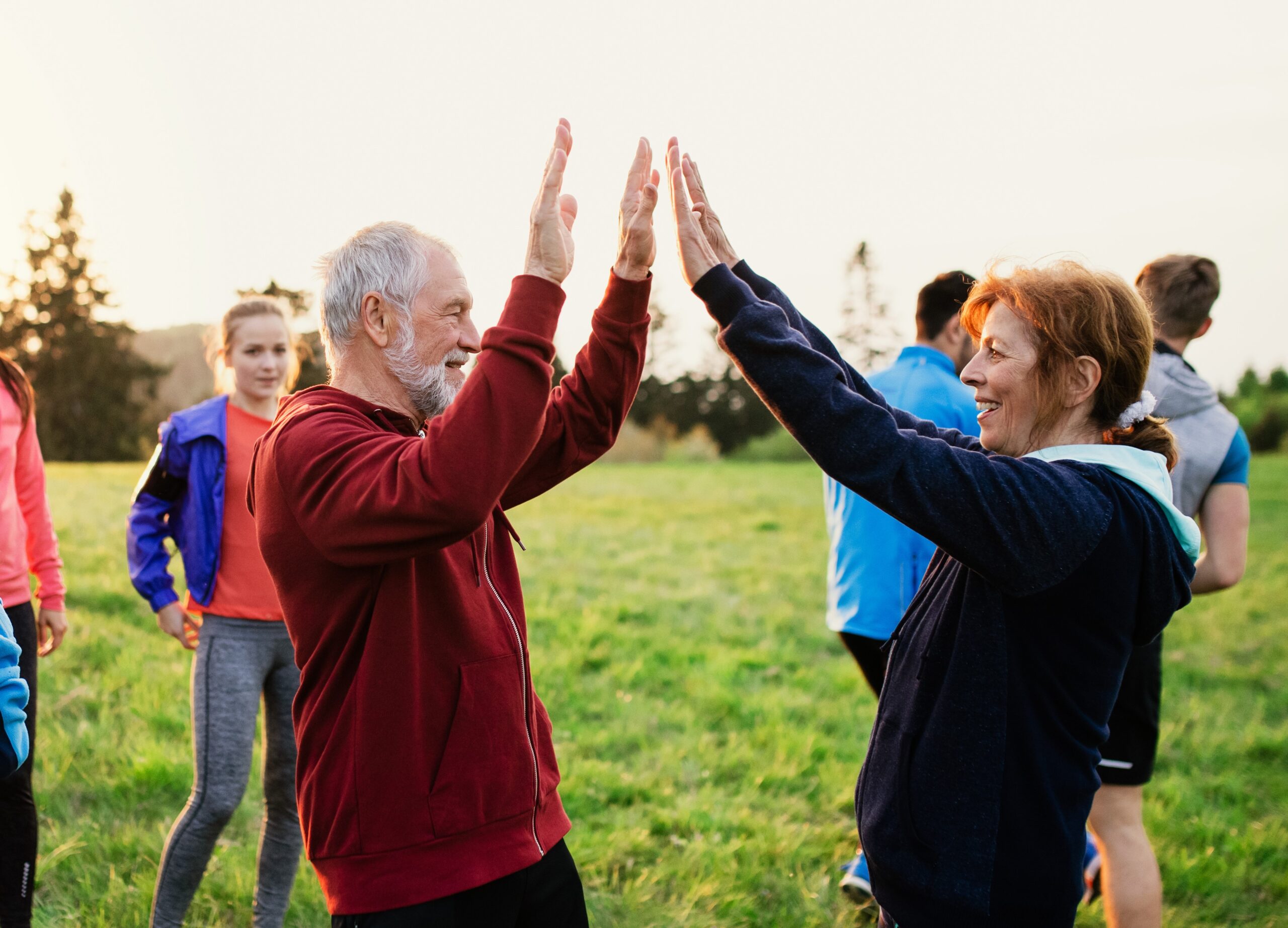 Large group of fit and active people resting after doing exercise in nature. A large group of fit and active people resting after doing exercise in nature.